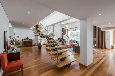 a spiral staircase in a living room with a table at Casas do Forte do Pico in Funchal