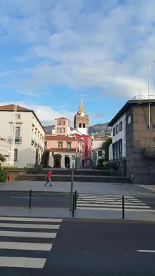 a person riding a skateboard down a city street at Edificio Charles 301 in Funchal