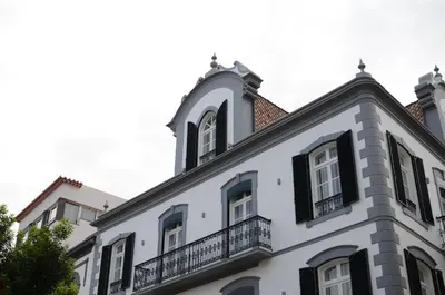 a white building with a balcony on top of it at Edificio Charles 301 in Funchal