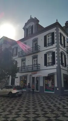 a large white building with a car parked in front of it at Edificio Charles 301 in Funchal