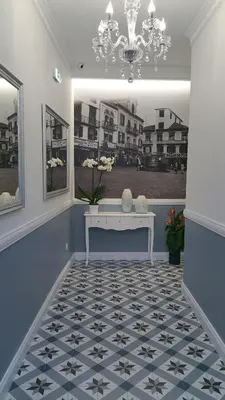 a hallway with a white bench and a chandelier at Edificio Charles 301 in Funchal
