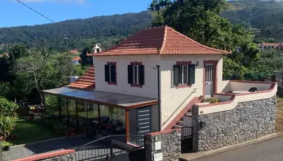 a small house with a stone wall at Casa da Maria in Prazeres