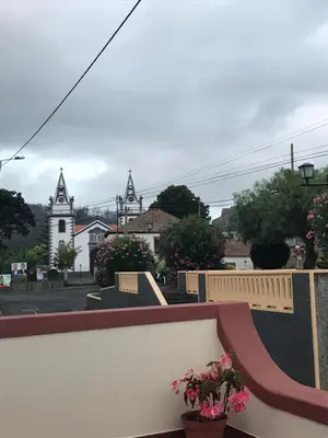a balcony with a view of a street and a church at Casa da Maria in Prazeres