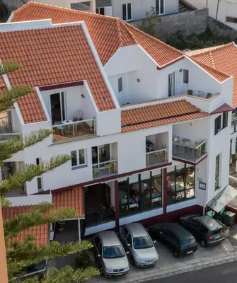 an aerial view of a house with cars parked in front at Residencial Familia in Machico