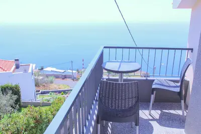 a balcony with two chairs and a table and a table at Studio One | Massapez | Fajã da Ovelha | Calheta in Fajã da Ovelha