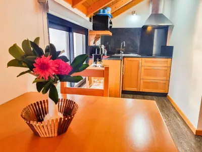 a kitchen with a wooden table with a vase of flowers on it at Studio One | Massapez | Fajã da Ovelha | Calheta in Fajã da Ovelha
