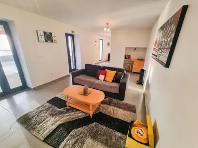 a living room with a couch and a table at House of Massapez | Calheta in Fajã da Ovelha