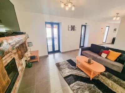 a living room with a couch and a fireplace at House of Massapez | Calheta in Fajã da Ovelha