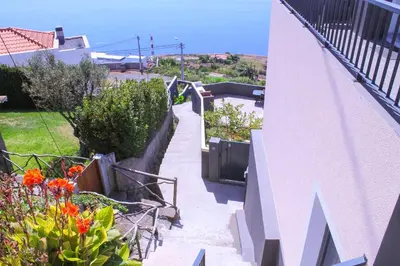 a stairway leading up to a house with flowers at House of Massapez | Calheta in Fajã da Ovelha