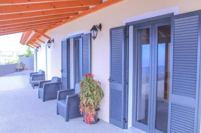 a row of blue shutters on the side of a building at House of Massapez | Calheta in Fajã da Ovelha