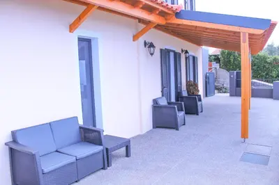 a group of chairs sitting on a patio at House of Massapez | Calheta in Fajã da Ovelha