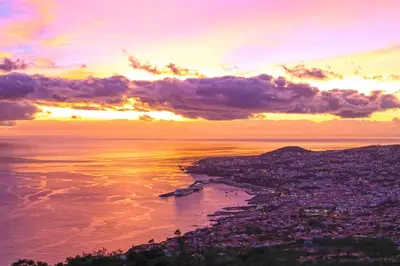a view of the ocean with a sunset in the background at Luxury One Bedroom Palheiro Village by Holiday Rental Madeira in Funchal