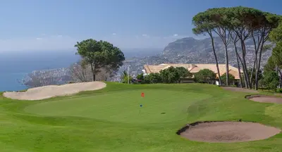 a view of a golf course with a green at Luxury One Bedroom Palheiro Village by Holiday Rental Madeira in Funchal