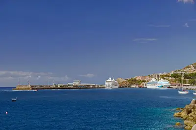 a view of a large body of water with boats at Arriaga I by An Island Apart in Funchal