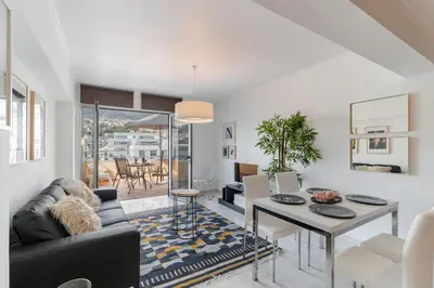 a living room with a couch and a table at Arriaga I by An Island Apart in Funchal
