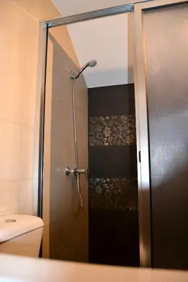 a shower with a glass door in a bathroom at Casa do Lado in Ponta do Sol