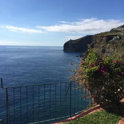 a view of the ocean from a cliff at Inn & Art Madeira in Caniço
