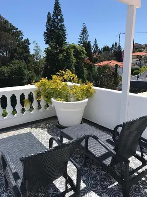 two chairs and a table on a patio at Inn & Art Madeira in Caniço