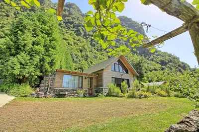 a small house with a mountain in the background at Chale Jardim De Cima in São Vicente