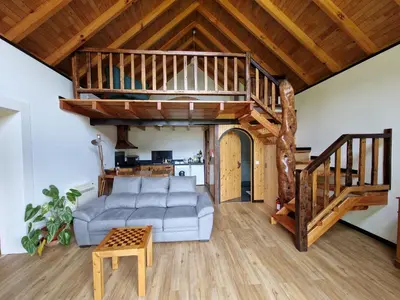 a living room with a staircase and a couch at Chale Jardim De Cima in São Vicente