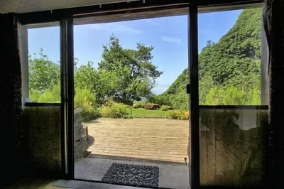 an open door with a view of a yard at Chale Jardim De Cima in São Vicente