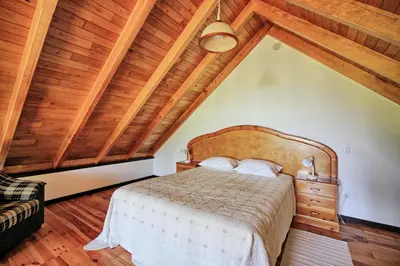 a bedroom with a bed and a wooden ceiling at Chale Jardim De Cima in São Vicente