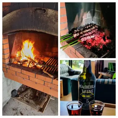 a brick oven with food and a bottle of wine at Chale Jardim De Cima in São Vicente