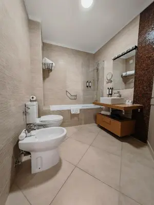 a bedroom with a large bed with a purple blanket at Sagres Time Apartamentos in Sagres