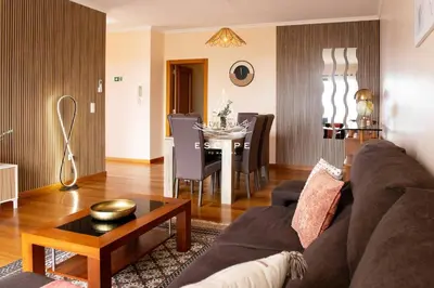 a living room with a couch and a table at Vila Sol in Prazeres