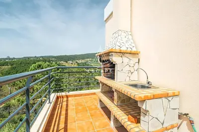 a balcony with a sink on the side of a building at Vila Sol in Prazeres