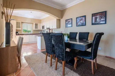 a kitchen and dining room with a table and chairs at Designed Villa Palheiro Village by Holiday Rental Madeira in Funchal