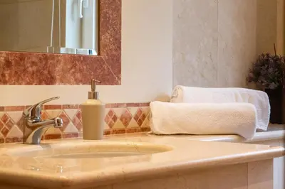 a bathroom sink with a soap dispenser on it at Designed Villa Palheiro Village by Holiday Rental Madeira in Funchal