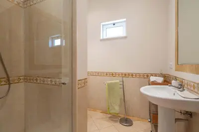 a bathroom with a shower and a sink at Designed Villa Palheiro Village by Holiday Rental Madeira in Funchal