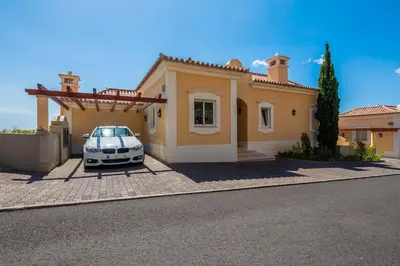 a car parked in front of a house at Designed Villa Palheiro Village by Holiday Rental Madeira in Funchal
