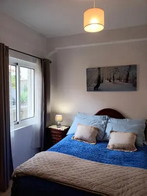 a bedroom with two beds and a window at Casa da Fonte dos Castanheiros in Estreito da Calheta