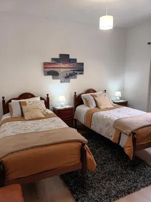 a bathroom with a sink and a shower with towels at Casa da Fonte dos Castanheiros in Estreito da Calheta