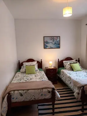 a small kitchen with wooden cabinets and a stove at Casa da Fonte dos Castanheiros in Estreito da Calheta