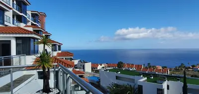 a view of the ocean from the balcony of a building at Apartamento Doreen in Caniço