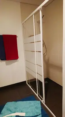 a shower with a glass door in a bathroom at Apartamento Doreen in Caniço