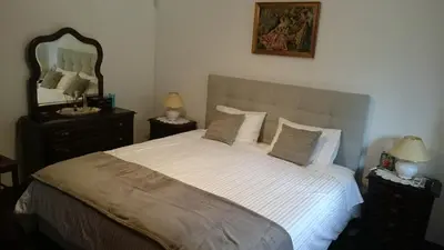 a bedroom with a bed and a tv on a dresser at Vila Pragelas in Santa Cruz