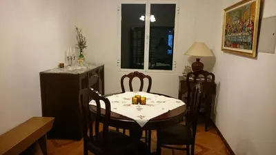 a blue couch in a living room with a table at Vila Pragelas in Santa Cruz