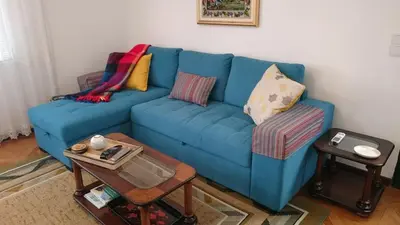 a living room with two chairs and a lamp at Vila Pragelas in Santa Cruz