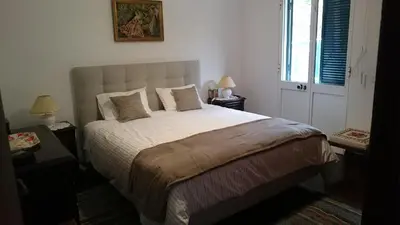 a bedroom with a large bed and a window at Vila Pragelas in Santa Cruz