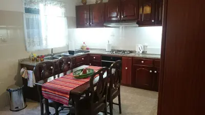 a kitchen with a table and a stove top oven at Vila Pragelas in Santa Cruz