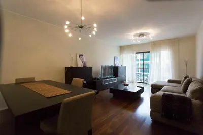 a living room with a table and a couch and a television at Elena's Apartment - Nice sea views in Panasqueira