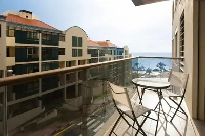 a balcony with a table and two chairs on a balcony at Elena's Apartment - Nice sea views in Panasqueira