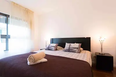 a bedroom with a large bed with towels on it at Elena's Apartment - Nice sea views in Panasqueira