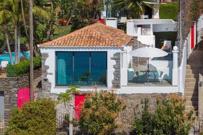 an aerial view of a house with a red door at OurMadeira - Cottage do Mar in Arco da Calheta