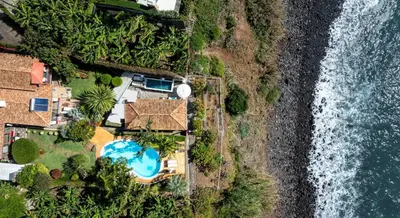 an aerial view of a house next to the ocean at OurMadeira - Cottage do Mar in Arco da Calheta