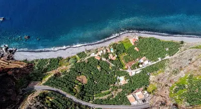 an aerial view of a road next to the ocean at OurMadeira - Cottage do Mar in Arco da Calheta